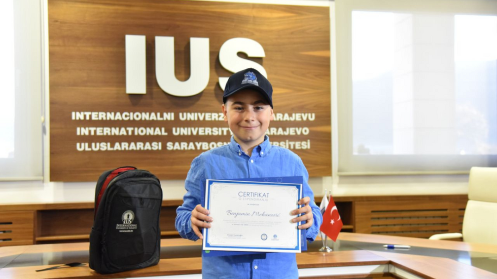 young boy receives university scholarship
