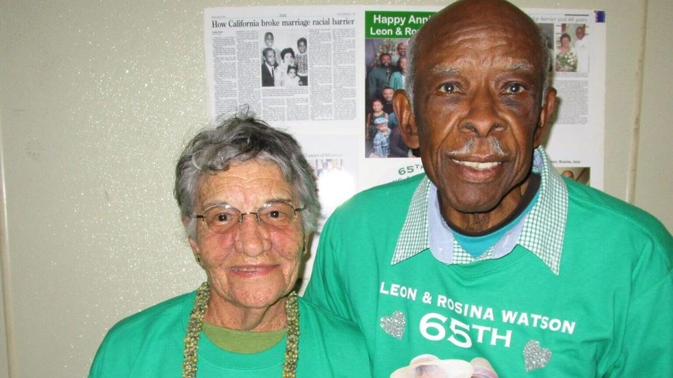 elderly man and elderly woman wearing green