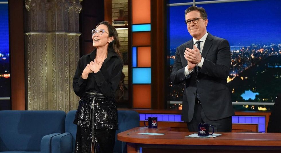 Michelle Yeoh standing on the Late Show with Stephen Colbert.