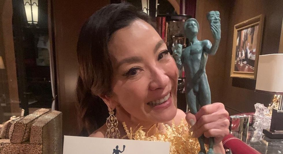 Michelle Yeoh holding her Oscar for Best Actress.