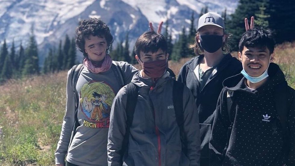 4 boys in front of a mountain