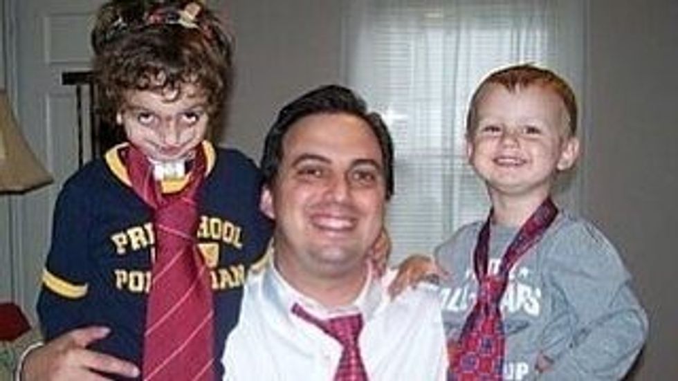 man with 2 kids, all wearing halloween costumes