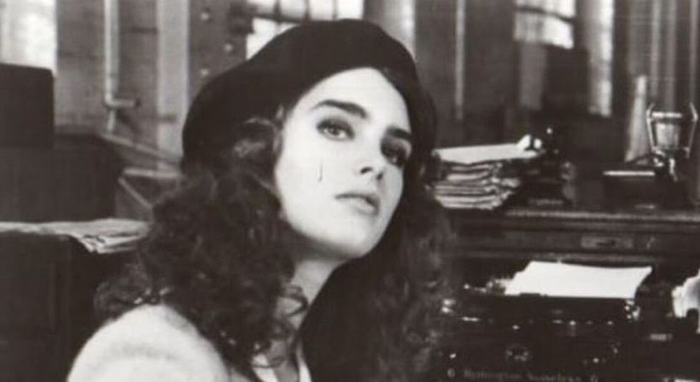 Black and white photo of young Brooke Shields wearing a hat.