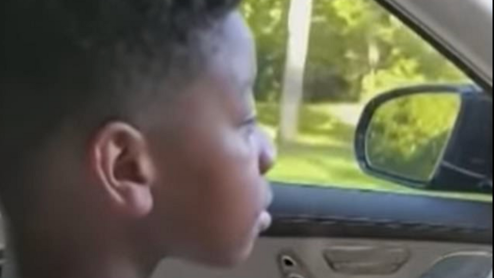 little boy driving a car