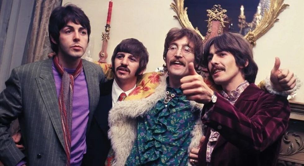 The Beatles in the 70s wearing bright clothing.