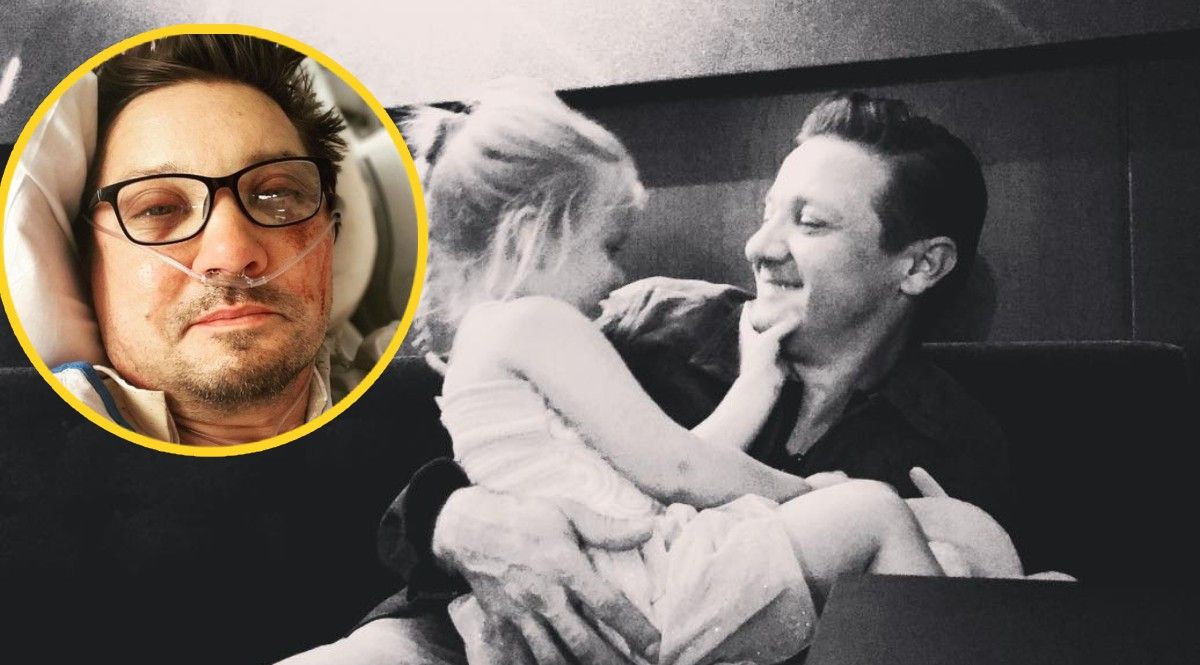 Jeremy Renner holding his daughter next to a picture after his snowplow accident.