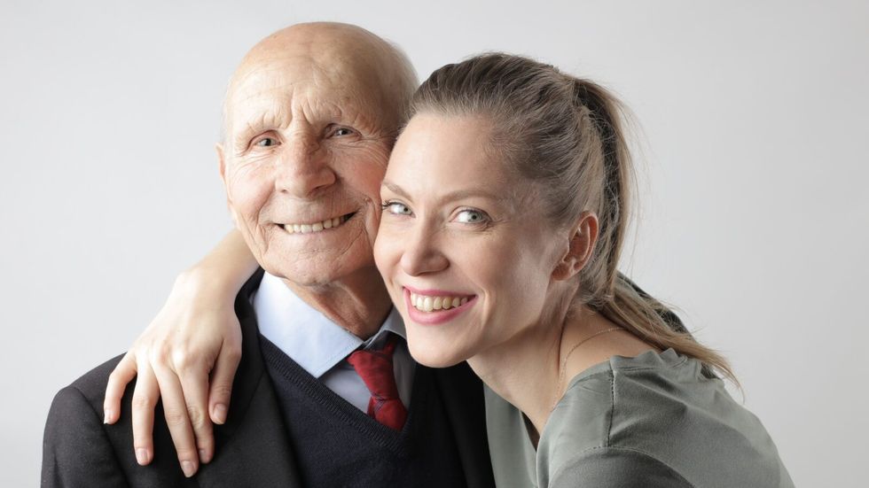 elderly man with a young woman