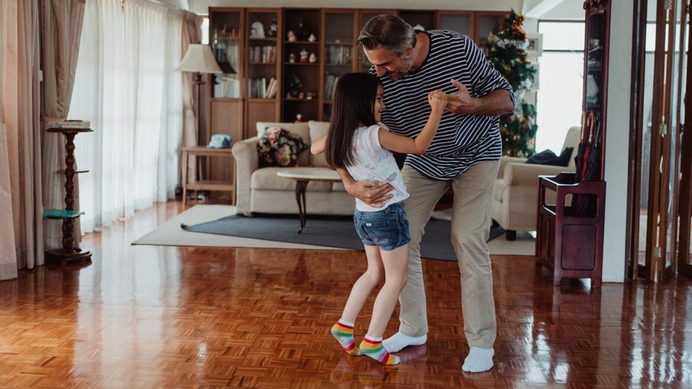 man dancing with his daughter