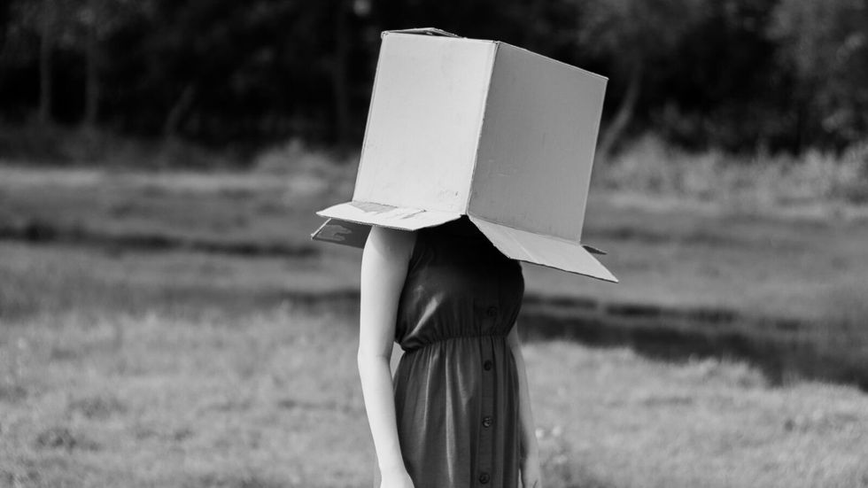 girl with a cardboard box on her head