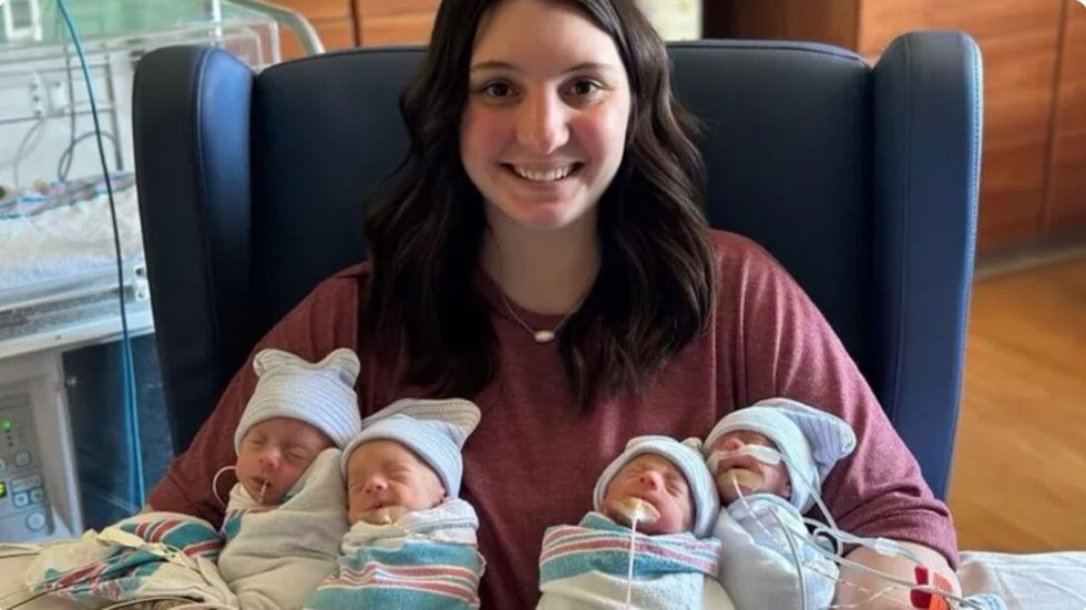 mother holding quadruplets