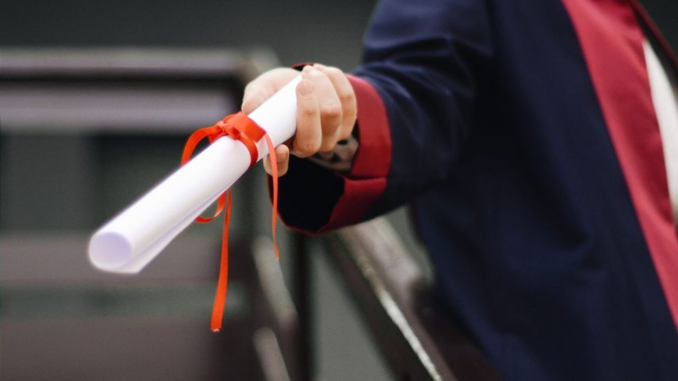 graduate holding a scroll in his hand