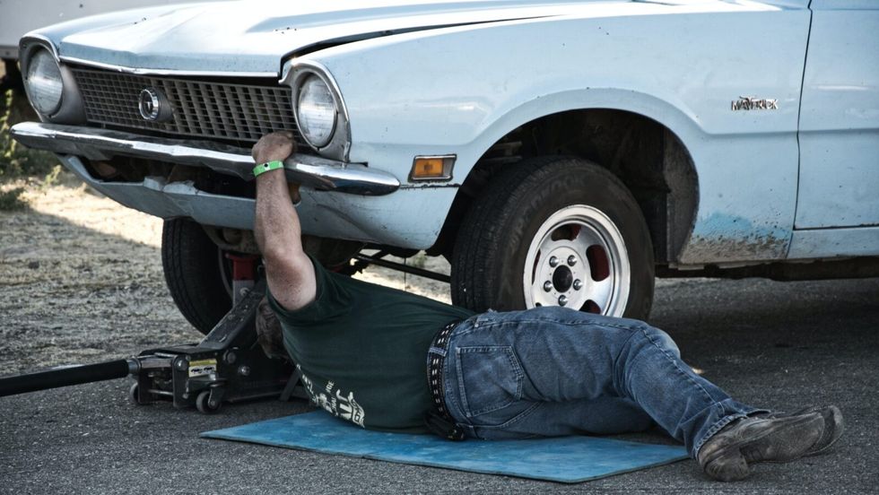 man working under his car