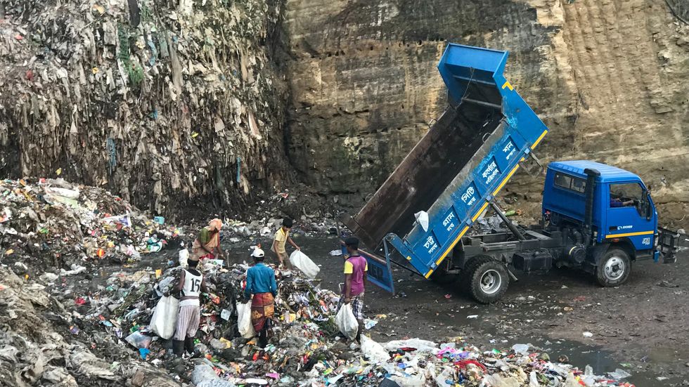 truck depositing trash in a landfill