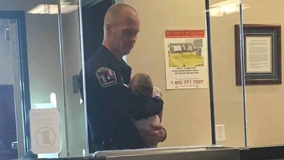 police officer holding a baby