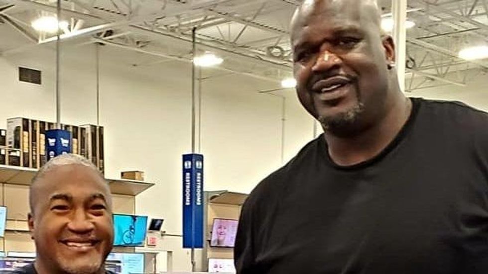 man standing with Shaquille O'Neal
