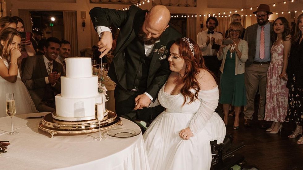 groom and bride cutting a wedding cake