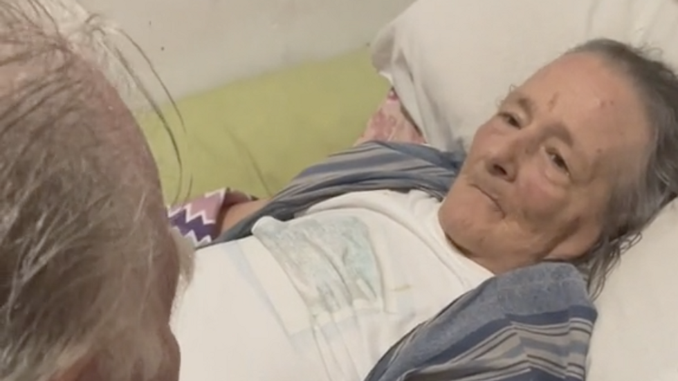 elderly woman lying in bed