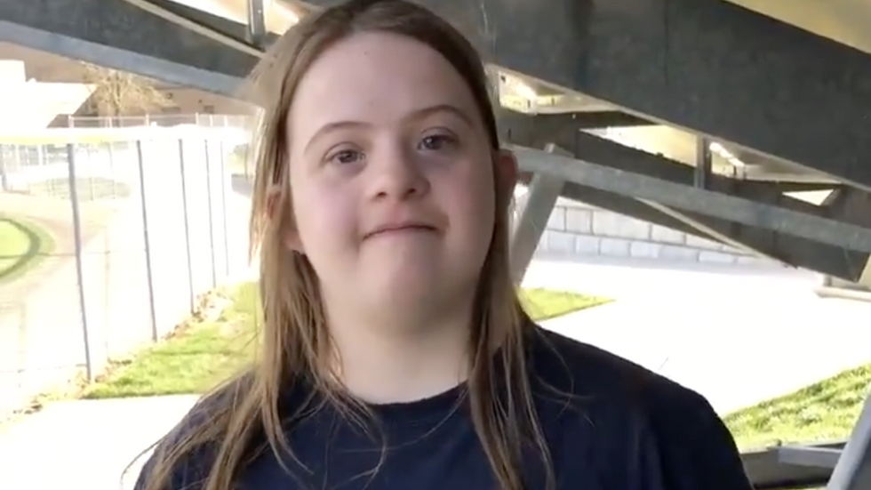 girl with Down Syndrome wearing a black tshirt