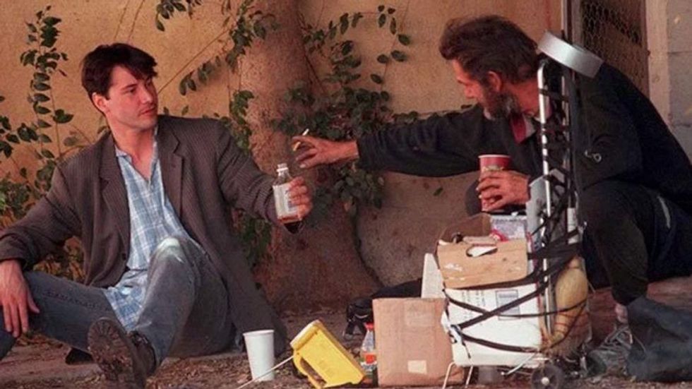 Keanu Reeves sharing a meal with a homeless man
