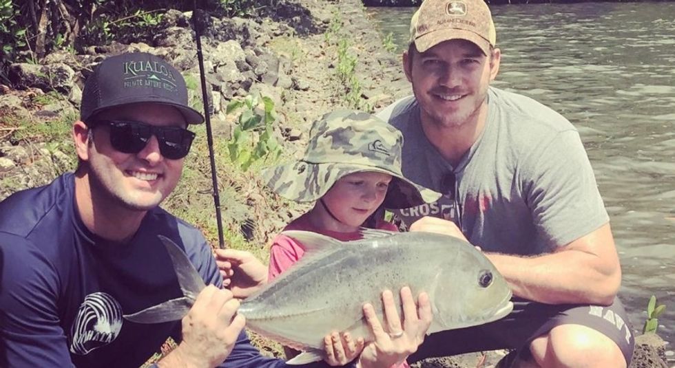 Chris Pratt and son Jack showing off the fish they caught.