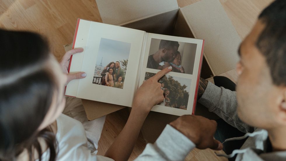 two people looking at a photo album