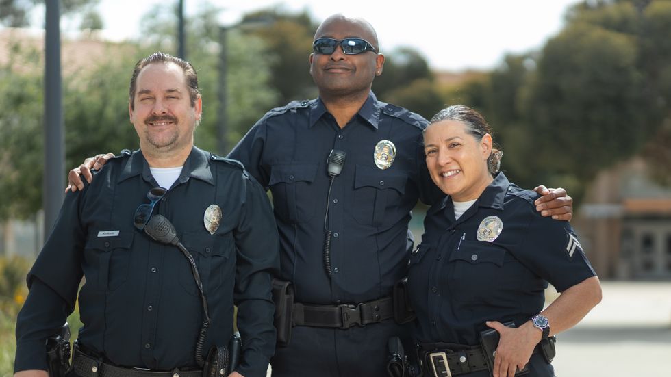two male police officers and a female police officer