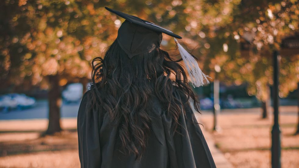 woman wearing a graduation gown and cap