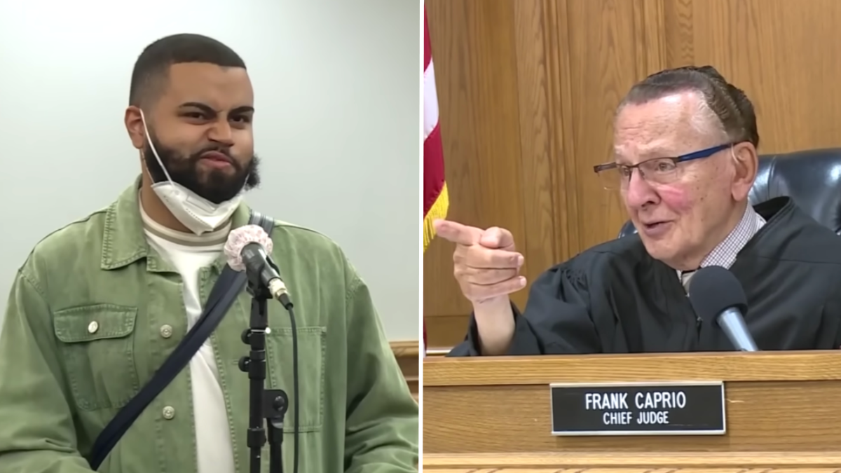 man wearing a green jacket and a judge a finger at the defendant