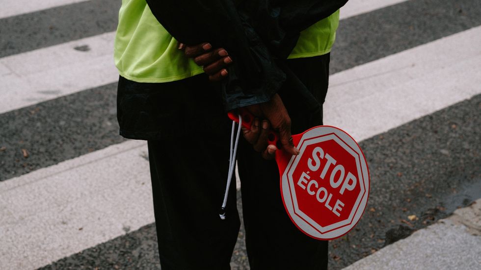 person holding a stop sign in their hands
