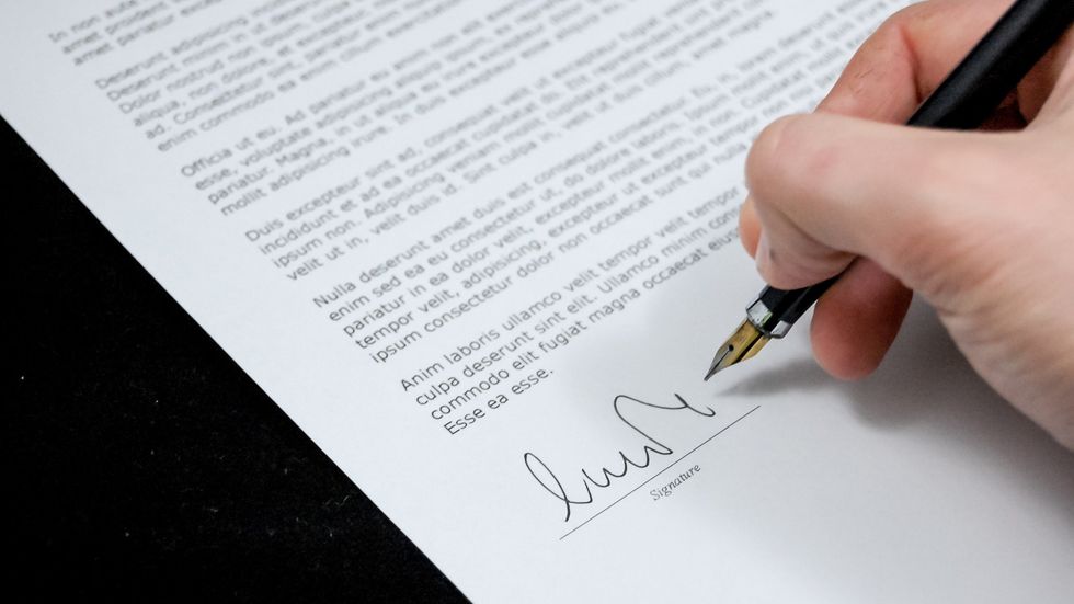 person signing a business document
