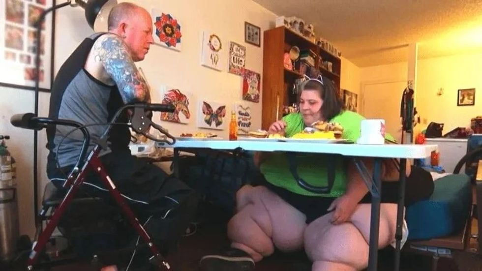 a man and woman eating food at a table