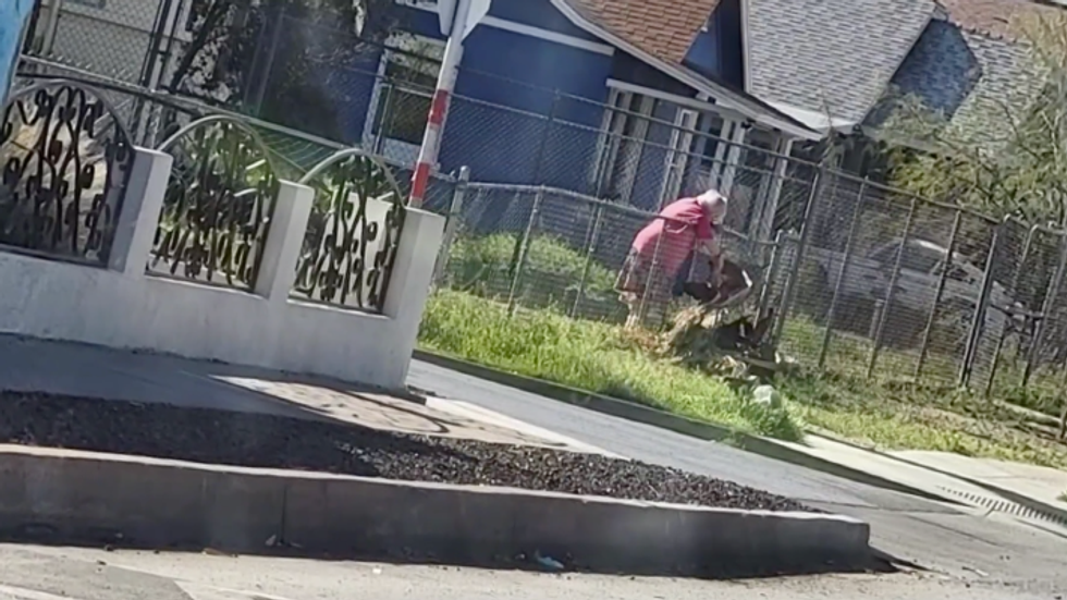 elderly woman working in her yard
