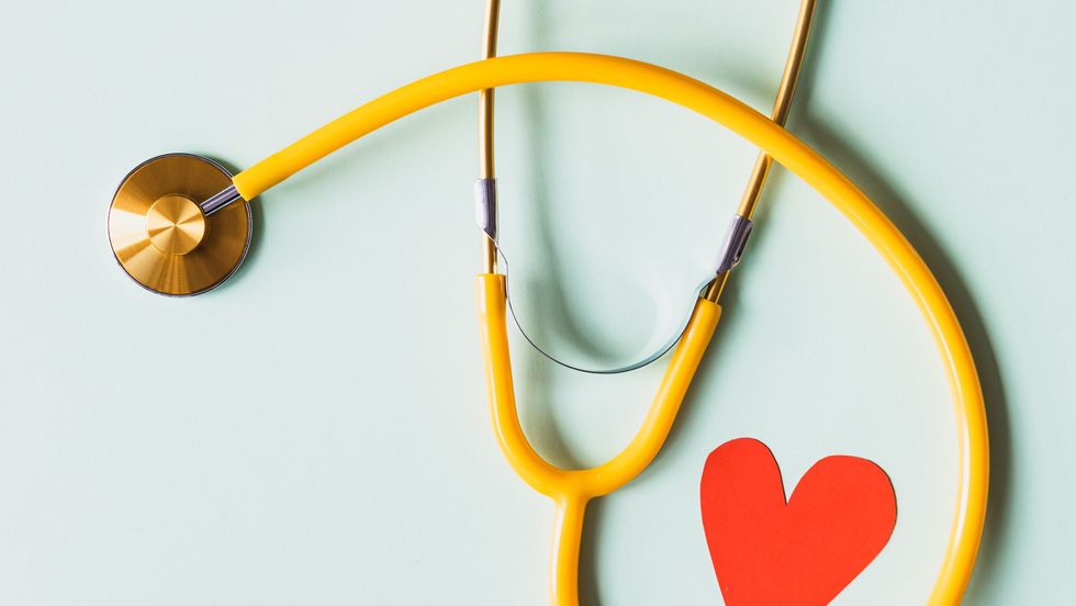 a yellow stethoscope next to a red heart