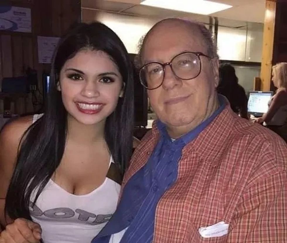 Hooters server with an elderly man