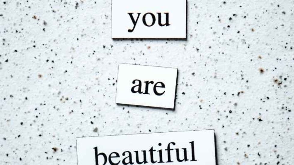 "you are beautiful" written on craps of paper