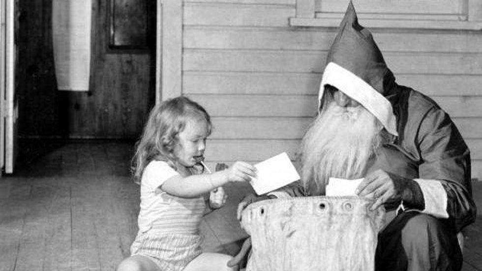 black and white photo of a little girl and a bearded man