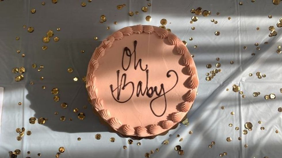 brown cake with "oh baby" written on it