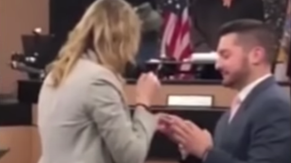 man proposing to his girlfriend in a courtroom