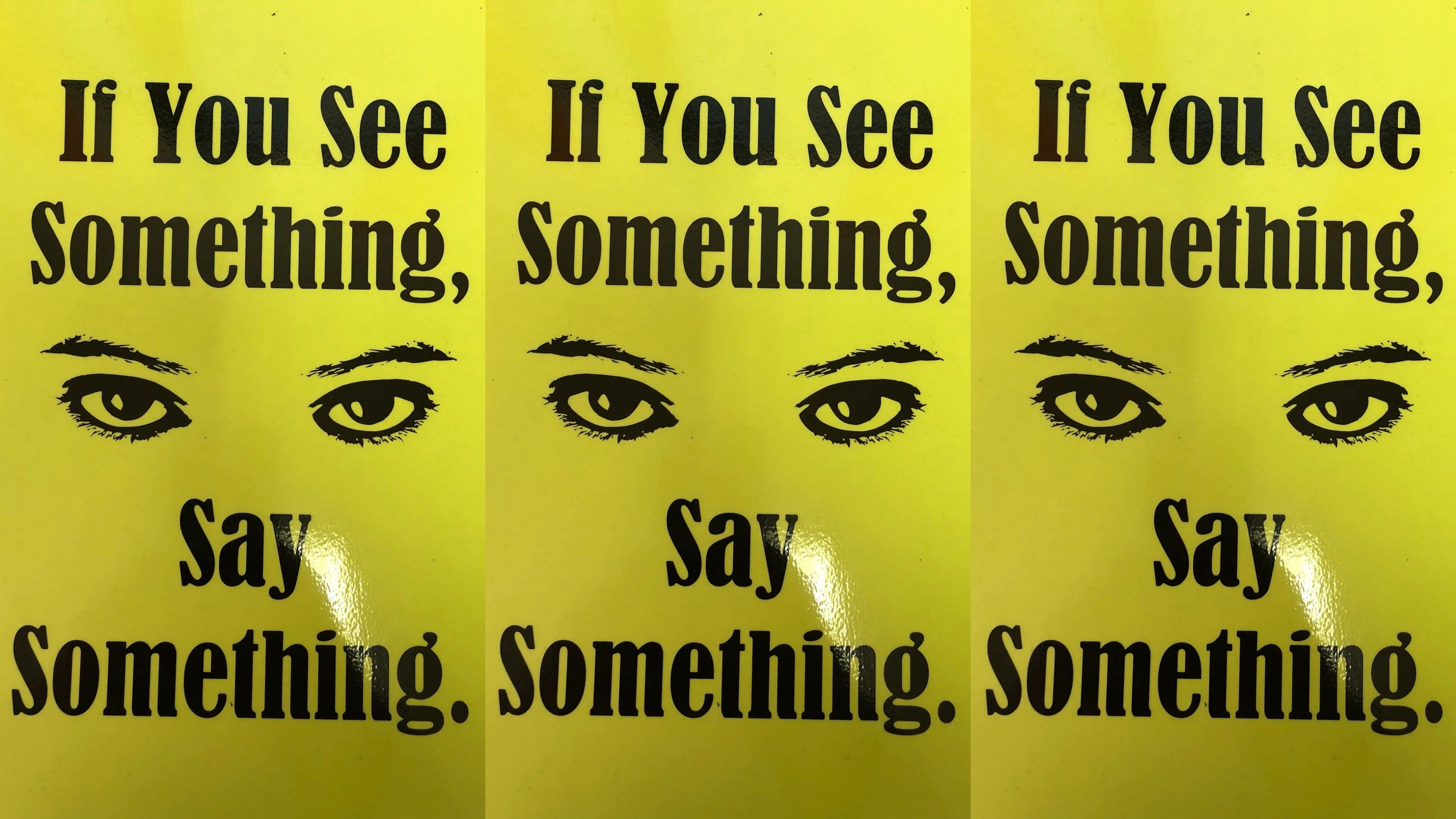 yellow posters with a pair of eyes at the center