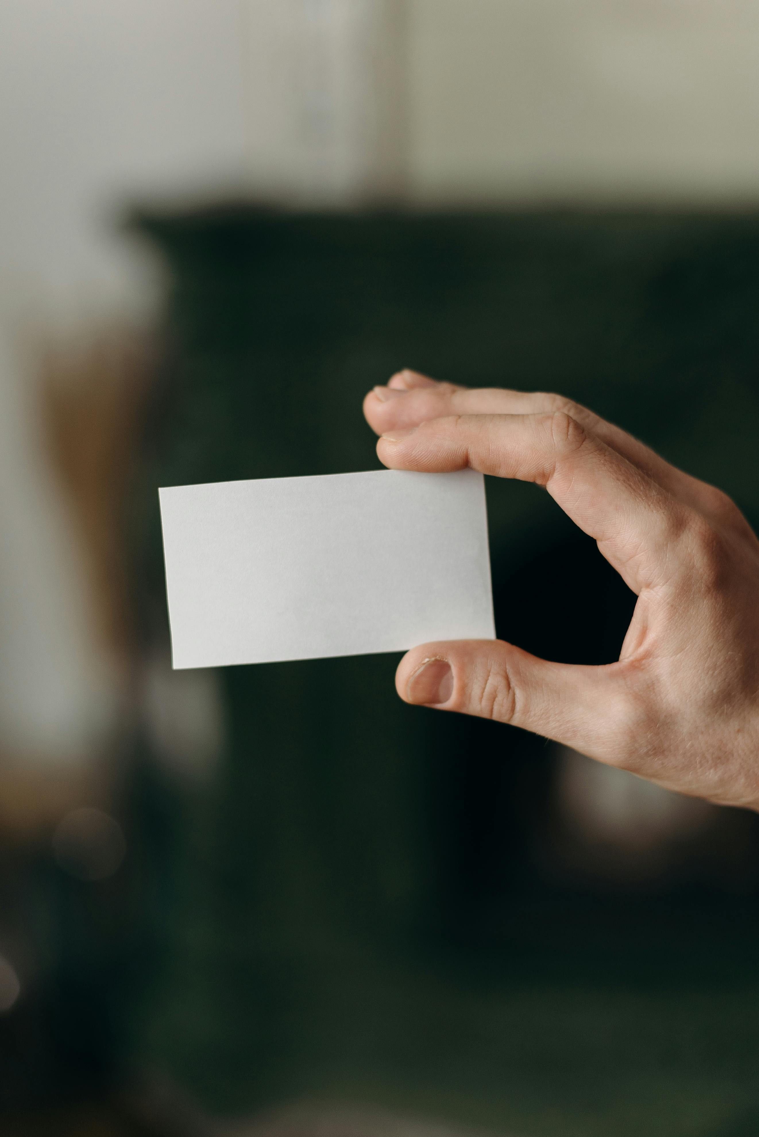 person holding a blank card 